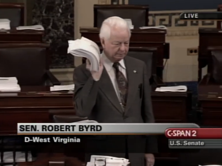 Senator Byrd holds up a copy of the Homeland Security Act of 2002 at a senate hearing.